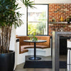 A kitchen table bar area with a black jute floor runner 