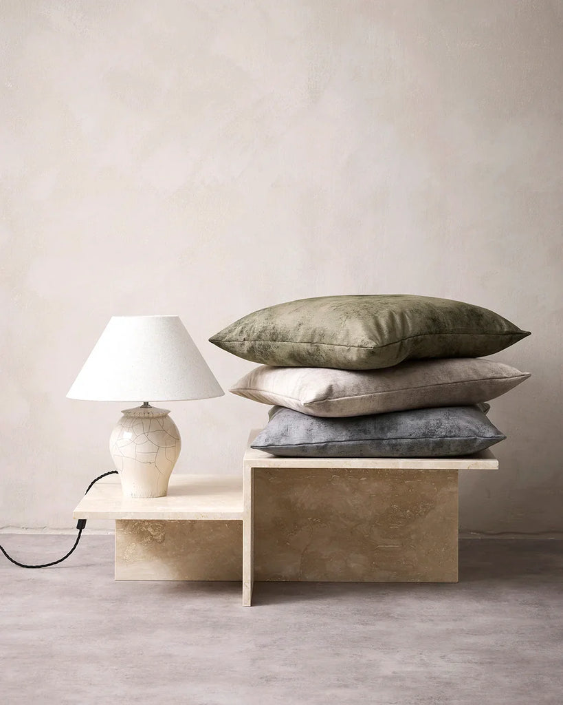 Pile of Baya velvet cushions in a contemporary home