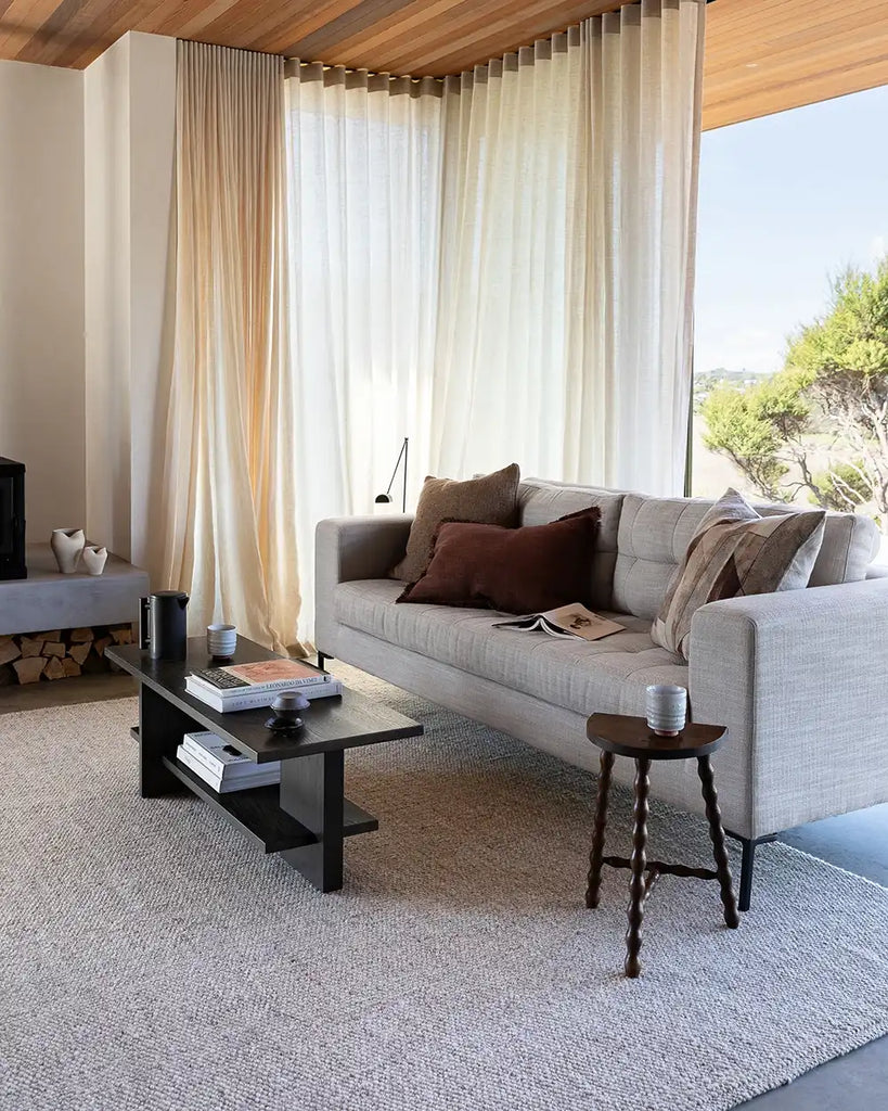 A rich red-brown lumbar cushion in a contemporary nz living room