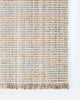 The Rhodes outdoor rug in brown and cream tones, seen at the corner from above to highlight the elegant weave
