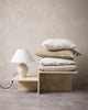 A stack of neutral and beige coloured cushions by Baya nz