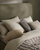 A stylish bed setting decorated with Weave Home nz bed linen and cushions