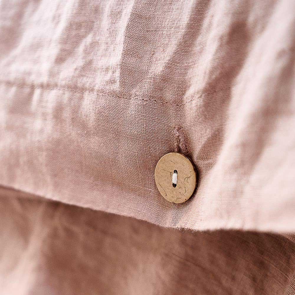 The buttons closing the French linen duvet cover in Lotus, by Eadie Lifestyle. 