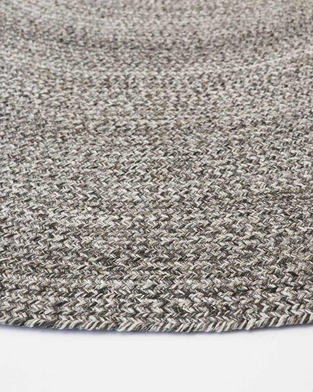 Close-up, corner view of the herringbone weave of Baya NZ's Mornington rug in Dark Pebble. 