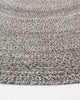 Close-up, corner view of the herringbone weave of Baya NZ's Mornington rug in Dark Pebble. 