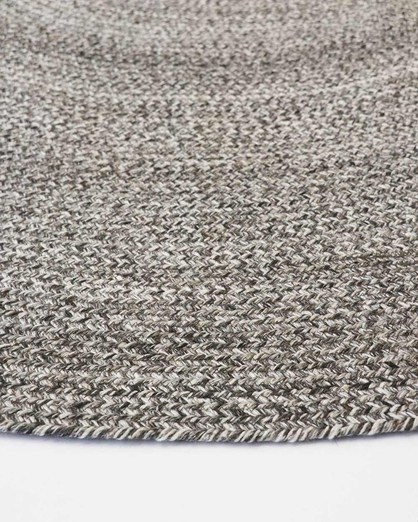 Close-up, corner view of the herringbone weave of Baya NZ's Mornington rug in Dark Pebble. 