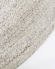 Close-up, corner view of the herringbone weave of Baya NZ's Mornington rug in Pale Sand. 
