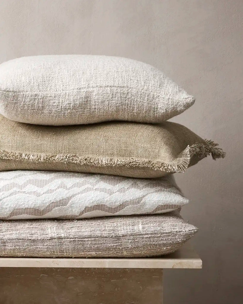 Stack of neutral cushions by Baya nz