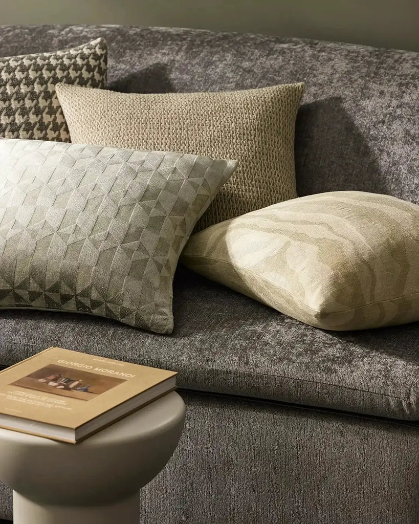 A variety of stylish neutral cushions on a couch