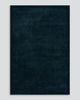 A full image of the Norfolk floor rug in the shade Ink. The border of the rug is cut-pile in a minimalist and refined design, and the pile of the rug's centre is luxuriously deep.
