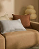 The 'Fiore Toffee' chocolate brown cushion on a lighter brown couchcouch 