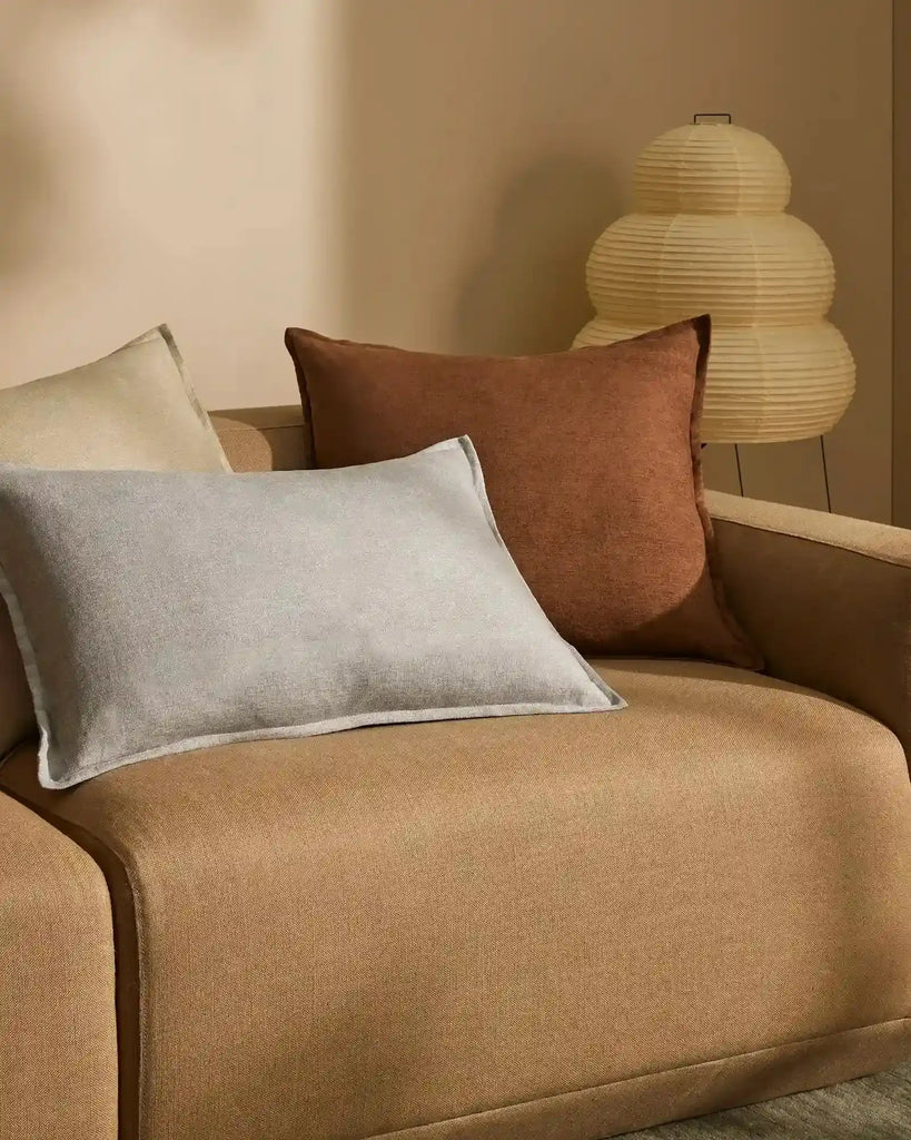 The 'Fiore Toffee' chocolate brown cushion on a lighter brown couchcouch 