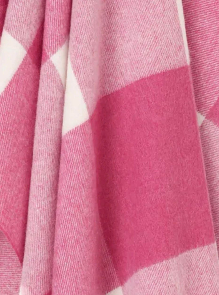 Close up of a NZ merino wool throw blanket in a pink and white check, by Exquisite Wool Blankets