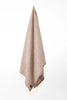 Palliser Ridge Herringbone throw in Chocolate hanging in full drape, showing the fringed edge