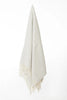 Palliser Ridge Herringbone throw in Dove Grey hanging in full drape, showing the fringed edge