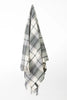 Palliser Ridge Twill Check lambswool throw in Forest, hanging to show the full check pattern