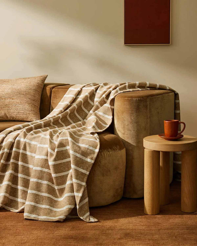 Soft brown striped throw blanket by Weave Home in a modern living room. 