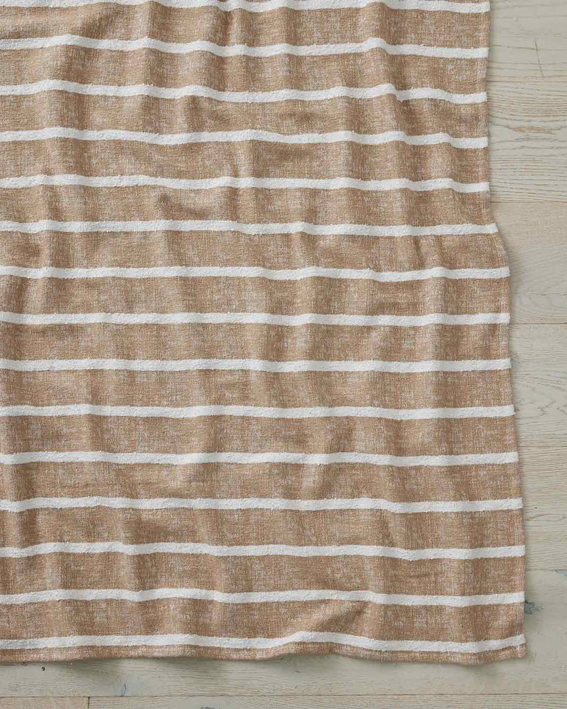 A full image of the Piazza throw in the soft brown shade Haze, by Weave Home.