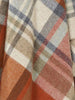 Close up of the gorgeous weave and rich warm colours of a 100% premium merino throw blanket. 