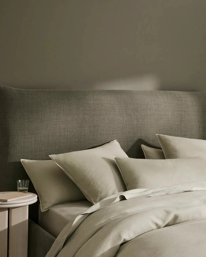 Sage green, French flax linen bedding on a made bed, by Weave Home nz