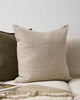 The Baya linen khaki pinstripe cushion next to a contrast green cushion