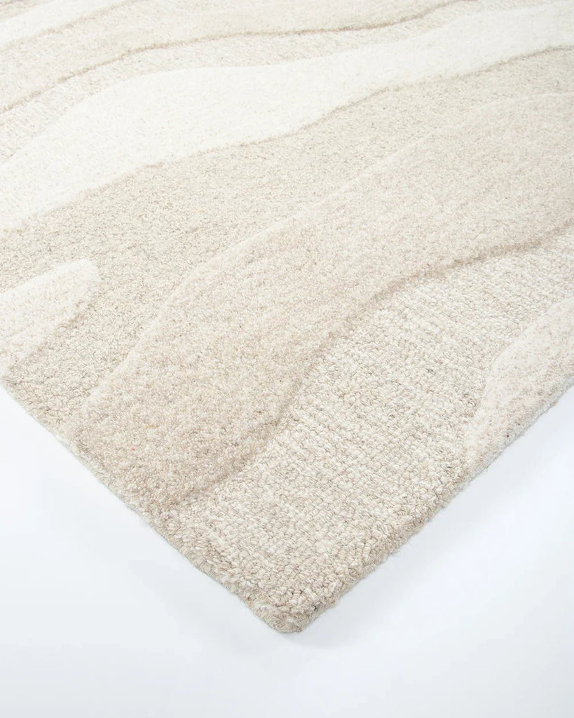 Corner of the 'Shoreline' wool rug, by Baya, showing textural cut and loop pile design