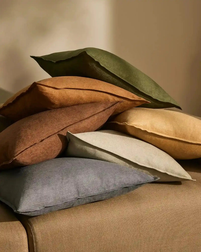 Stack of earthy toned cushions by Weave Home nz