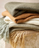 Close up of the Baya Richmond wool-blend throw blankets in earthy tones