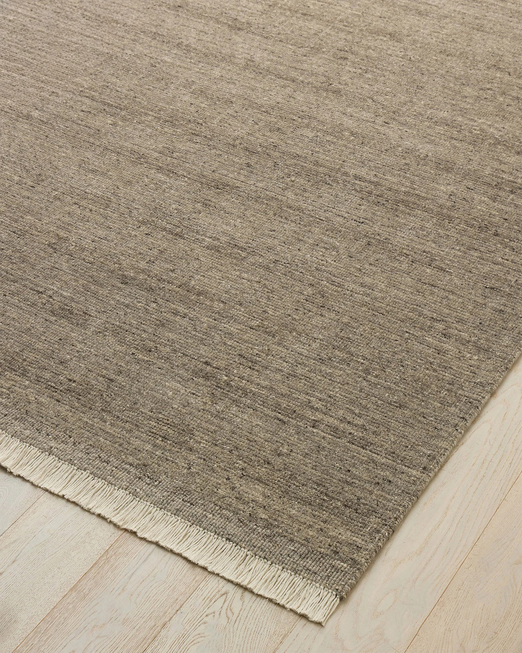 Weave Home Anton wool rug in Ash on a pale timber floor