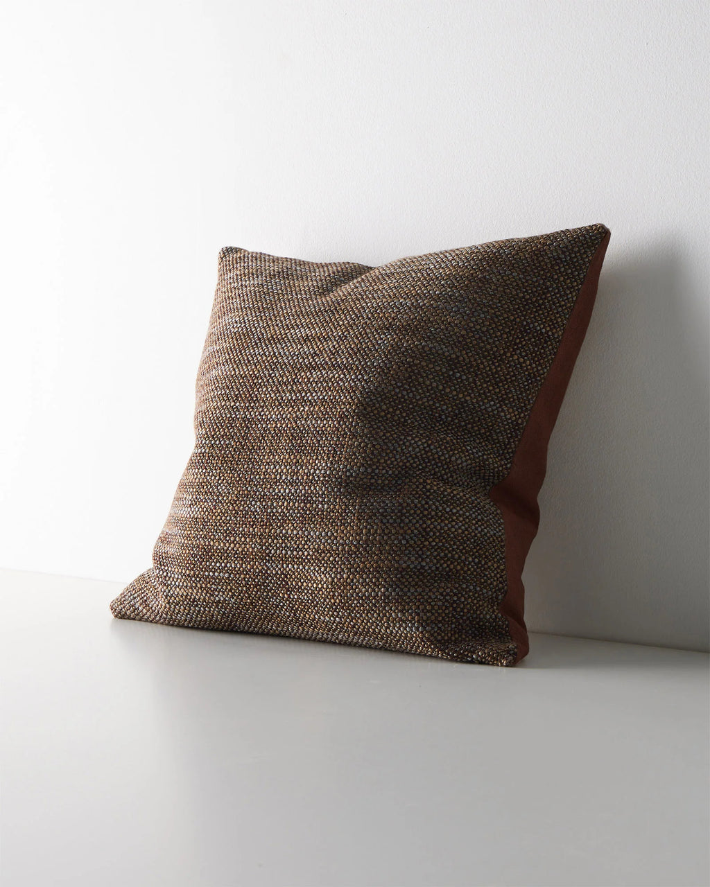 Weave Home Castel cushion in Auburn, shown from an angle on a plain background.