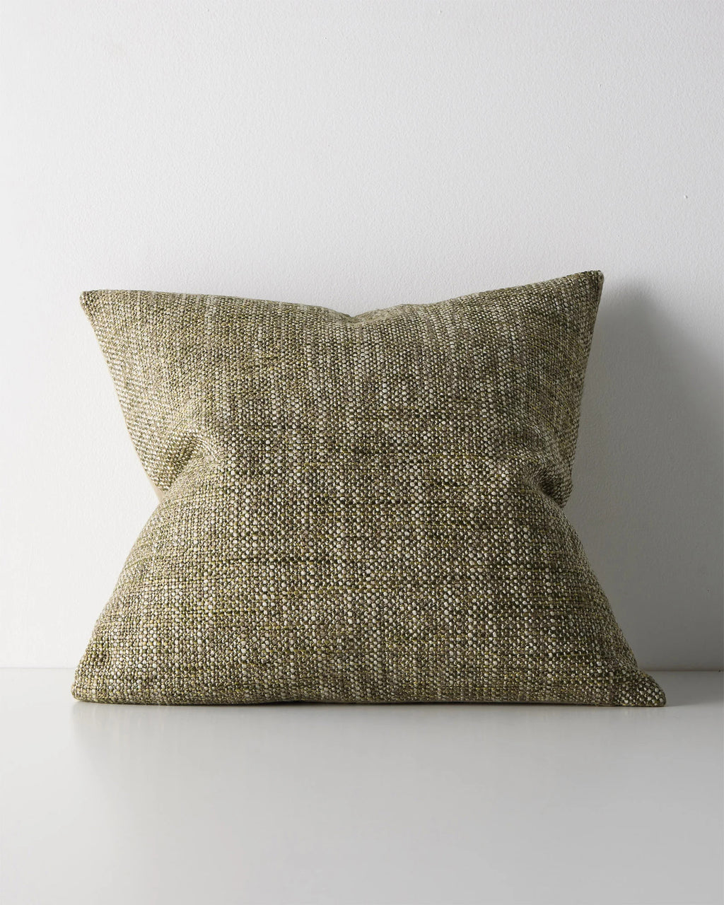 Weave Home Castel cushion in Moss on a plain background.