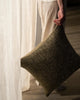 Weave Home Castel cushion in Moss held beside a linen curtain.