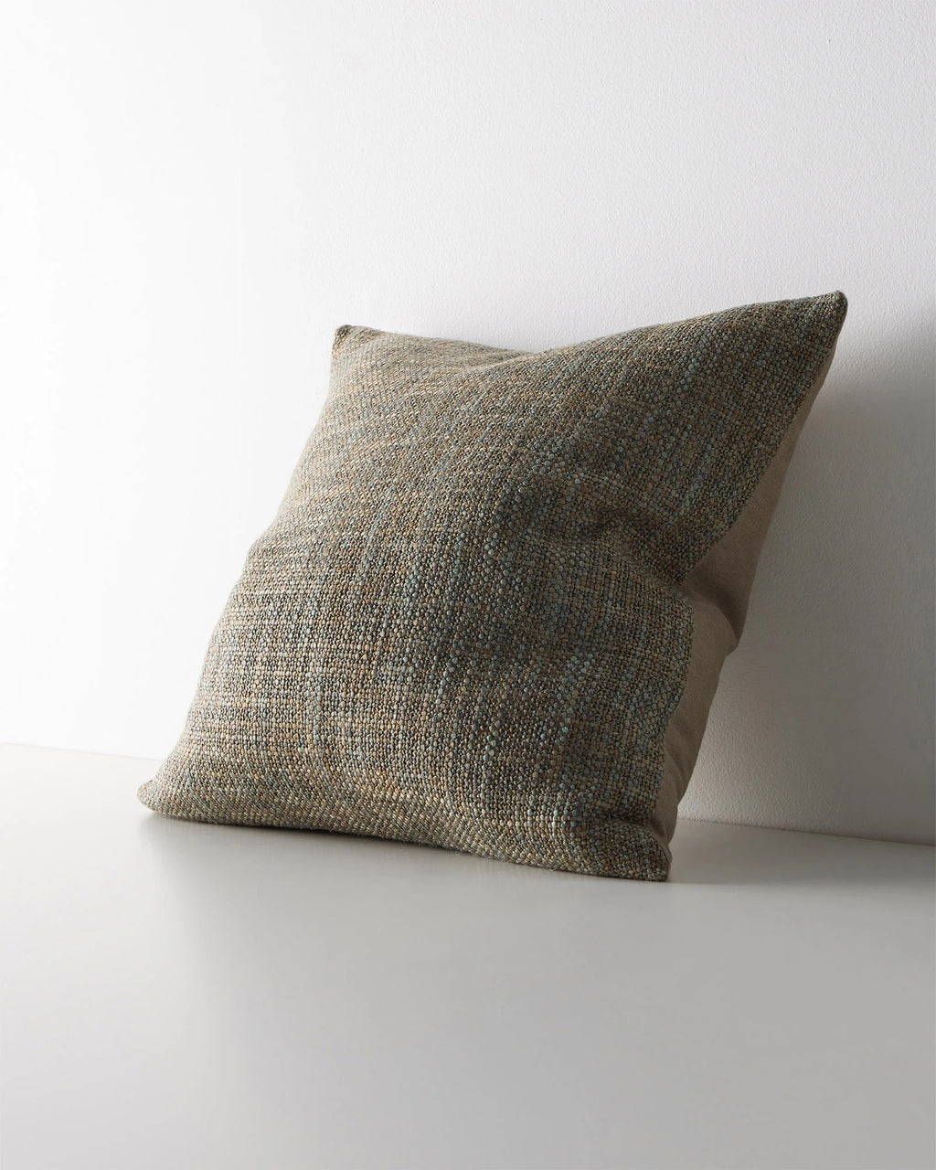 Weave Home Castel cushion in Tide, shown from an angle on a plain background.
