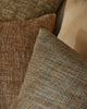 Weave Home Castel cushion in Tide layered with brown and olive cushions.