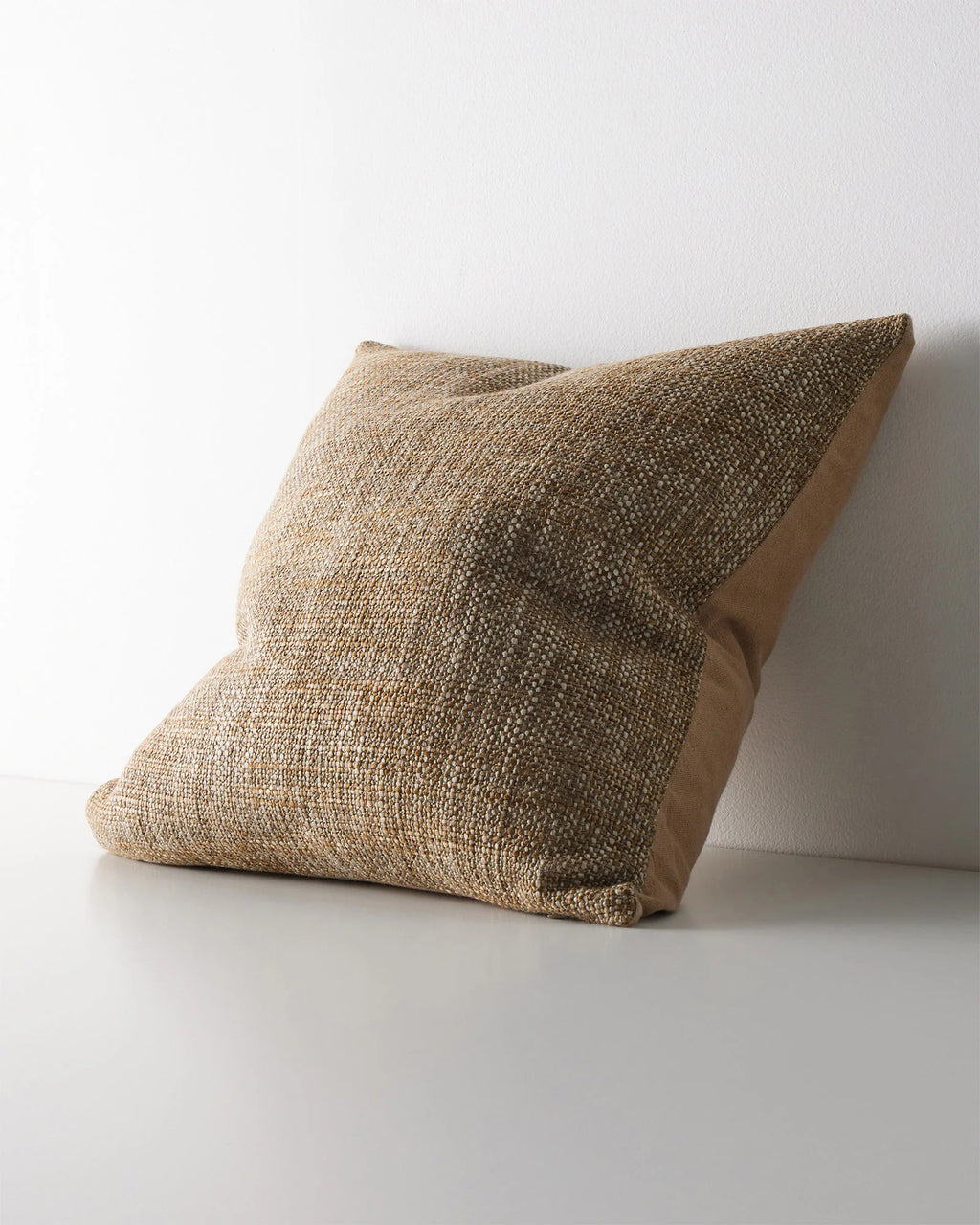 Weave Home Castel cushion in Toffee, shown from an angle on a plain background.
