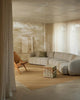 Weave Home Jacqueline wool rug in Brulee, styled in a living room with a sofa and timber armchair.