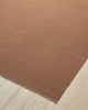 Weave Home Jacqueline wool rug in Rosewood on a pale timber floor, showing the fringed corner