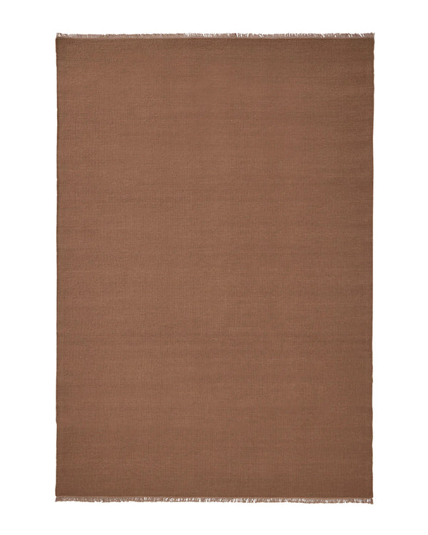 Weave Home Jacqueline wool rug in Rosewood on a plain background, shown flat with fringed ends