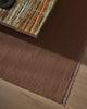 Weave Home Jacqueline wool rug in Rosewood, close view of the flatweave beneath a stone-topped table