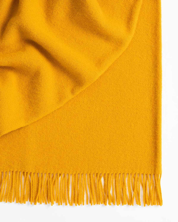 A bright, sunshine yellow throw blanket by Weave Home