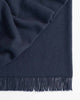 A dark blue throw blanket by Weave Home