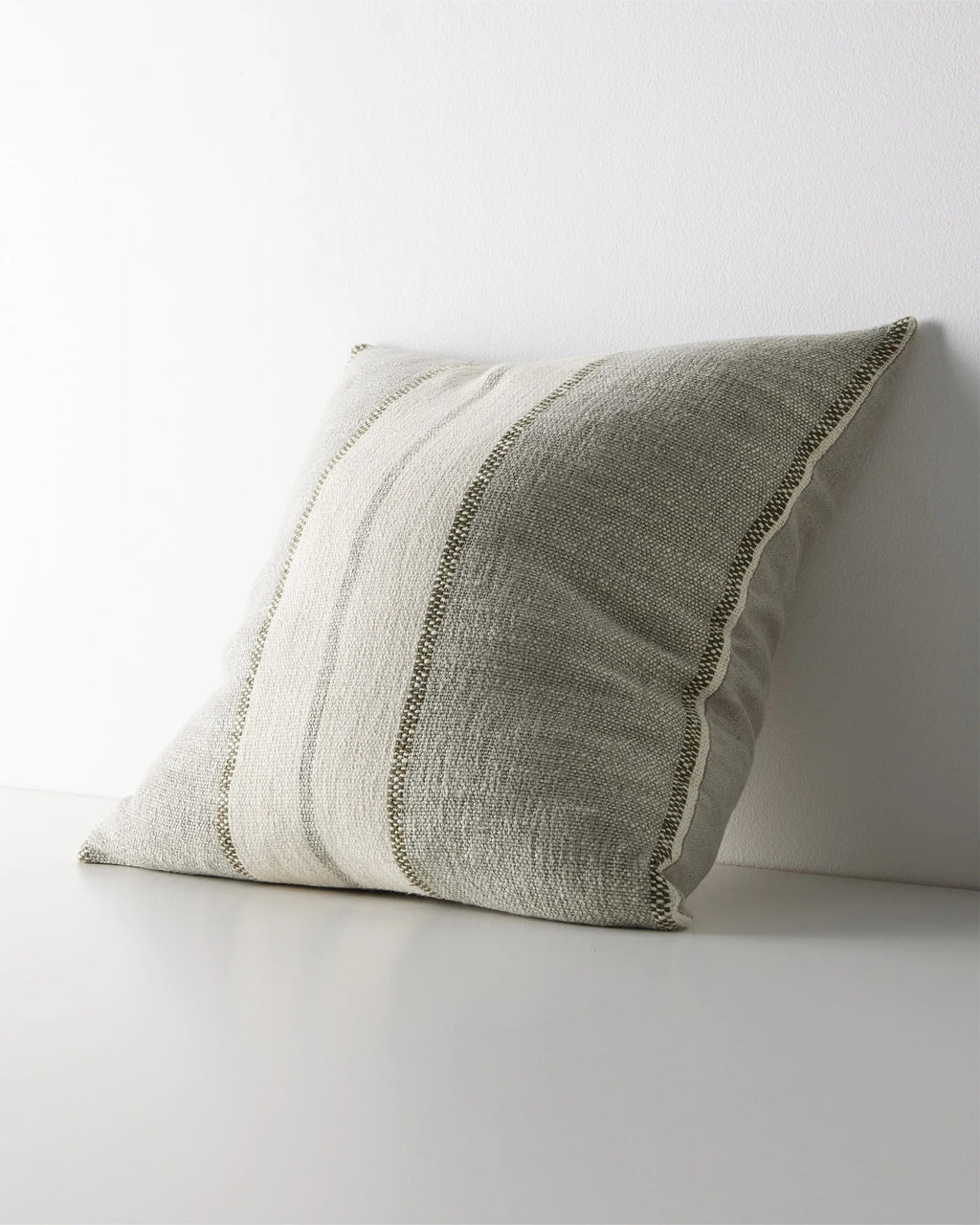 Weave Home Ottavio cushion in Lagoon, shown from an angle on a plain background.