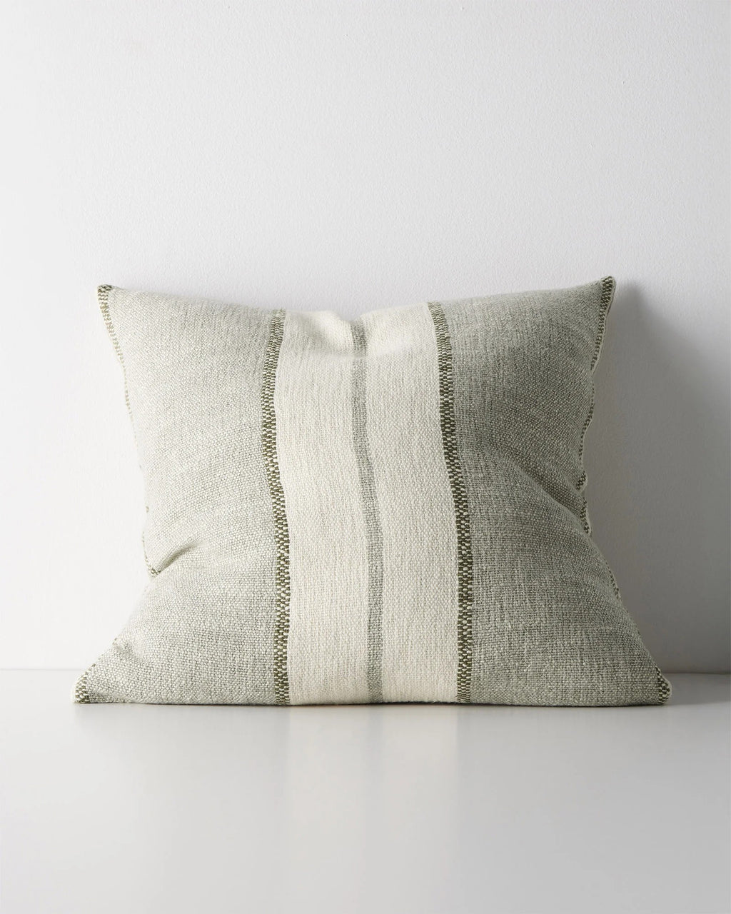 Weave Home Ottavio cushion in Lagoon on a plain background.
